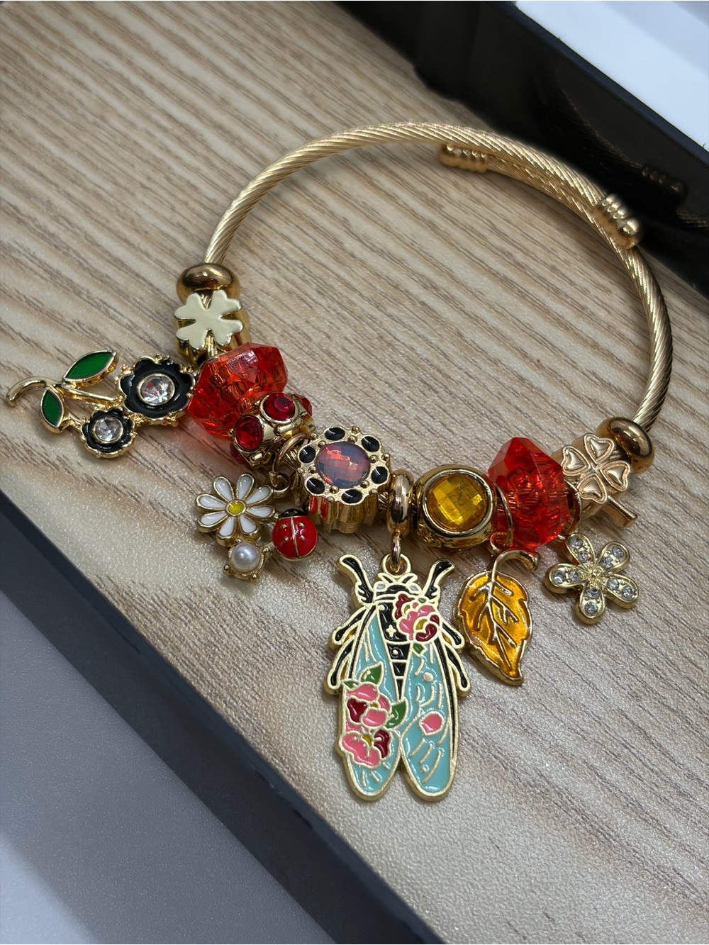 Gold-Tone Floral & Red Crystal Charm Bracelet with Enamel Insect Pendant